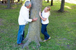 Smiling mature couple standing at tree
