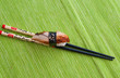 Sushi with chopsticks shot on green Sushi with chopsticks shot on green