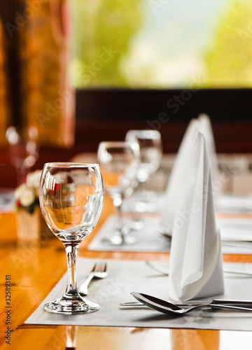 Photo: Glasses and plates on table in restaurant Glasses and plates on table in restaurant