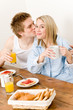 Breakfast happy couple enjoy romantic kiss Breakfast happy couple enjoy romantic kiss