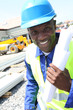 Construction worker on building site with security helmet