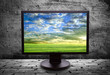 monitor with thea picture of of pure field against the gray wall
