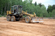 The grader clears away
