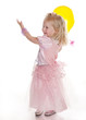 Photo: little girl gleefully playing with yellow balloon little girl gleefully playing with yellow balloon