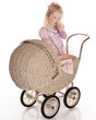 Photo: cute little girl sucking thumb and baby stroller carriage cute little girl sucking thumb and baby stroller carriage