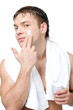 Man putting on cream lotion on face