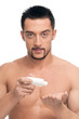 Foto: Young man applying cream. Cosmetic Young man applying cream. Cosmetic