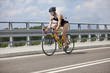 Triathlete biker pedaling on race bicycle