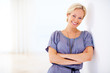 Beautiful young woman standing with hands folded