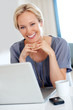 Attractive young lady smiling with a laptop