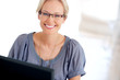 Happy young woman working in office