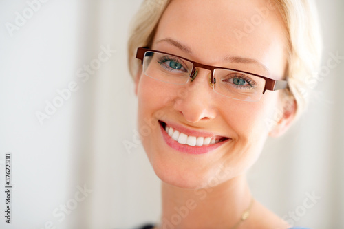 Photo: Portrait of happy young lady wearing glasses Portrait of happy young lady wearing glasses