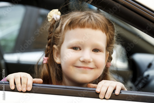 Photo: Cute little girl in a car Cute little girl in a car