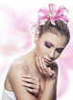 beautiful young sexy woman with flowers on colorful background