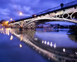 Photo: Sevillie, romantic panorama of the bridge and the riverside Sevillie, romantic panorama of the bridge and the riverside