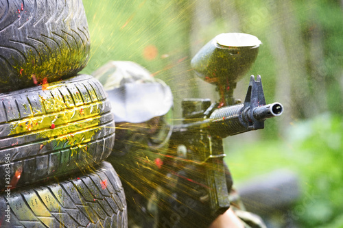 Photo: paintball player under gunfire paintball player under gunfire
