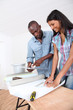 Couple choosing new wallpaper for room