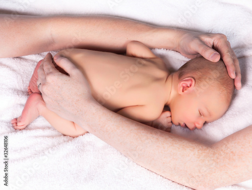 Photo: Parents hands protecting a baby Parents hands protecting a baby