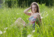 Photo: Happy girl sitting in a grass Happy girl sitting in a grass
