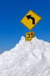 Snow Surrounding Curve Road Sign