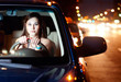 Young woman driving car in the night city Young woman driving car in the night city