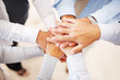 Office workers hold hands together Office workers hold hands together