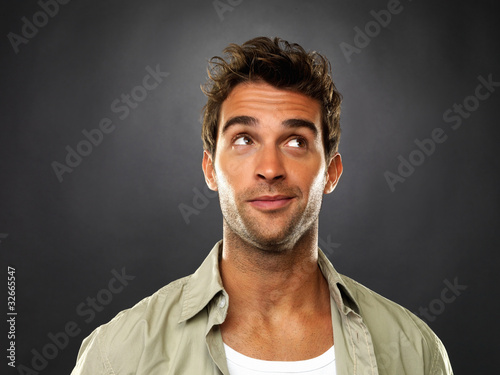 Foto: Smart man looking up and smiling Smart man looking up and smiling