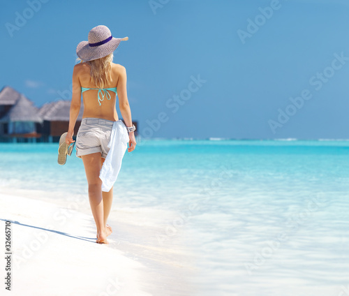 Photo: Sensual young woman walking through the beach - Copyspace Sensual young woman walking through the beach - Copyspace