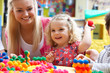 Young woman playing with girl