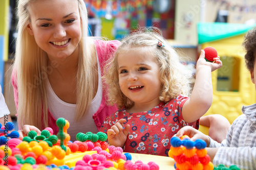 Photo: Young woman playing with girl Young woman playing with girl