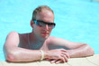 Foto: Portrait of a young handsome man in the pool Portrait of a young handsome man in the pool