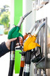 Man holding a gasoline nozzle in his hand