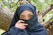 Young Arab girl with ancient olive tree