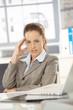 Young businesswoman sitting tired in office