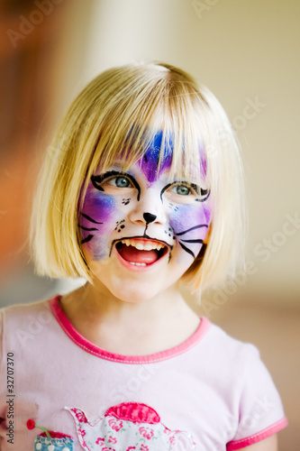 Photo: A happy young girl with face-paint on after a carnival A happy young girl with face-paint on after a carnival
