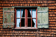 Ancient window on log house wooden wall