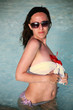 Young woman in the pool with a flower
