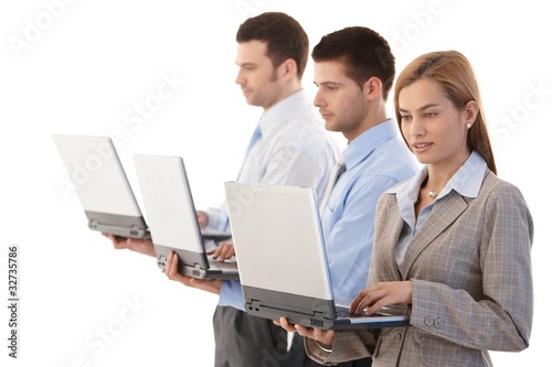 Photo: Young businesspeople with individual laptops Young businesspeople with individual laptops