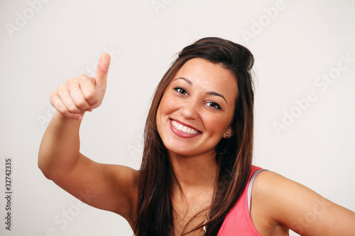 Photo: Thumbs up - smiling ethnic female Thumbs up - smiling ethnic female