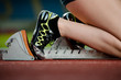 Detailed view of a female sprinter in the starting blocks