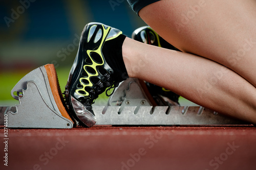 Photo: Detailed view of a female sprinter in the starting blocks Detailed view of a female sprinter in the starting blocks
