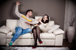 A man threatening to slap his girlfriend with taped mouth