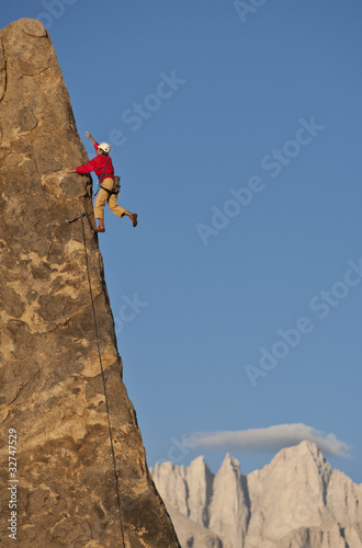 Photo: Rock climber rappelling. Rock climber rappelling.