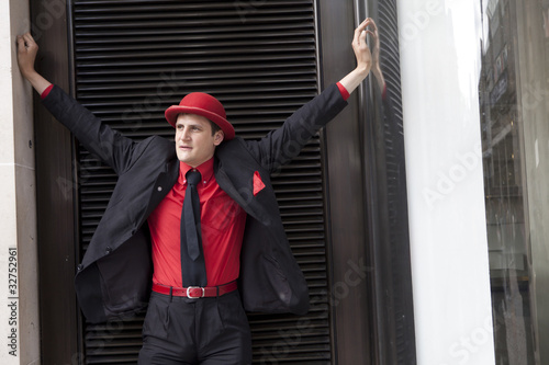 Photo: young serious man in red hat young serious man in red hat