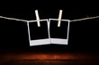 two blank instant photos on the background of a wooden table