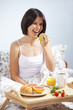 Woman having breakfast in bed