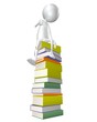 Man sitting on stack of books Man sitting on stack of books