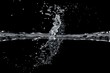 Two waterjet collide on a black background
