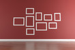 White picture frames on red wall