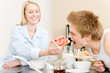 Breakfast happy couple man feed woman toast Breakfast happy couple man feed woman toast
